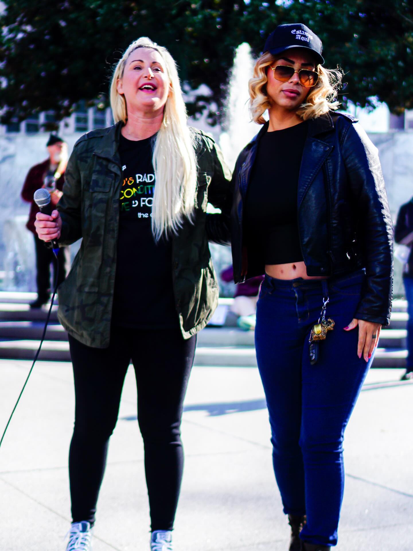Two community leaders standing together at a justice rally